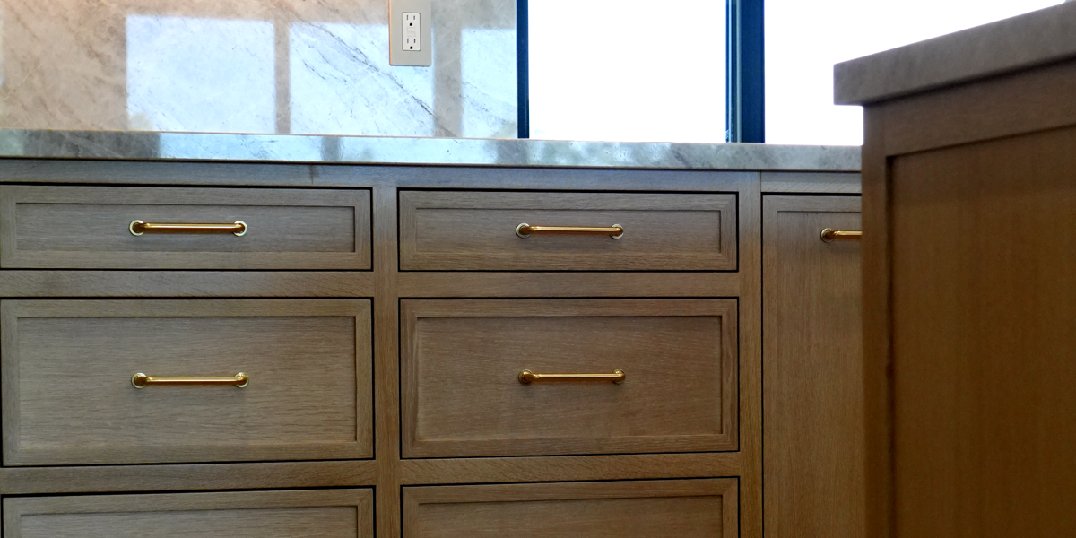 Green kitchen with wood island and wall panels